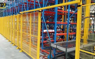 fence guarding wide-shot of yellow Mdfence warehouse security fence beside racking and conveyor zone for dense scrap sorting centers