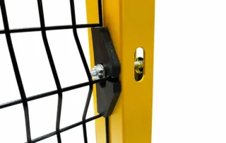 Safety fence construction close-up of industrial safety fence panel clamped to yellow steel post with bolt-mounted connector