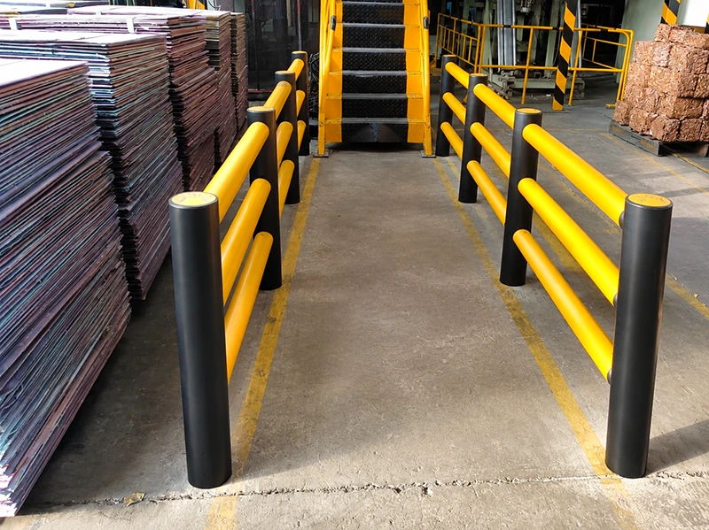 ARMORFLEX Barrier factory-installed yellow dual-rail safety barrier with black bollards for pedestrian and equipment segregation.