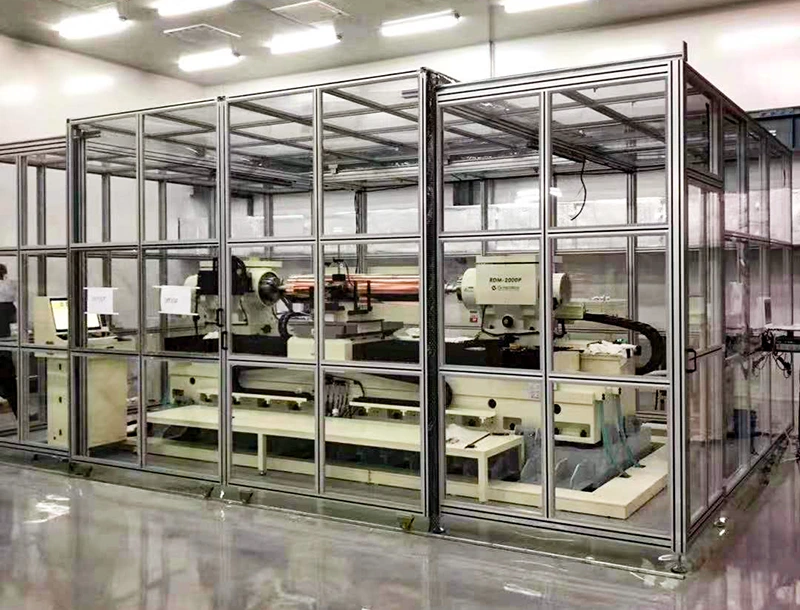 Aluminum safety fence with transparent panels surrounding automated production equipment