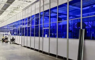 Perimeter guarding for phased automated warehouse expansion with modular aluminum safety fence and integrated access door