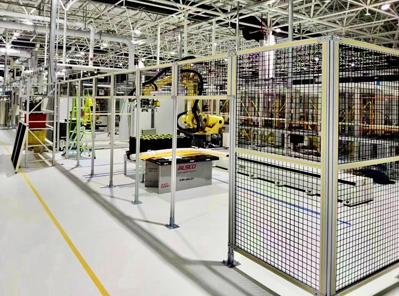 Perimeter guarding with anchored modular wire mesh panels around an automated robot cell
