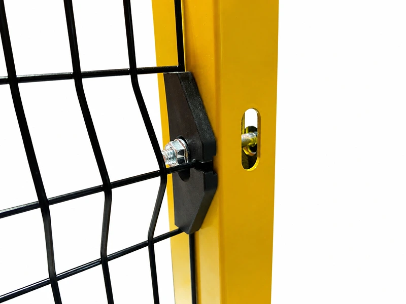 Close-up of industrial safety fence panel clamped to yellow steel post with bolt-mounted connector