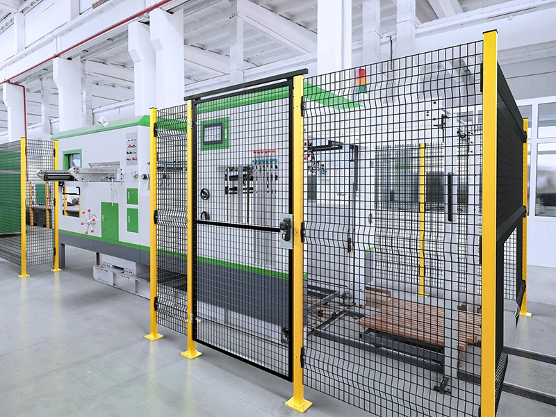 Industrial Safety Fencing around automated machinery with yellow posts and a single access gate