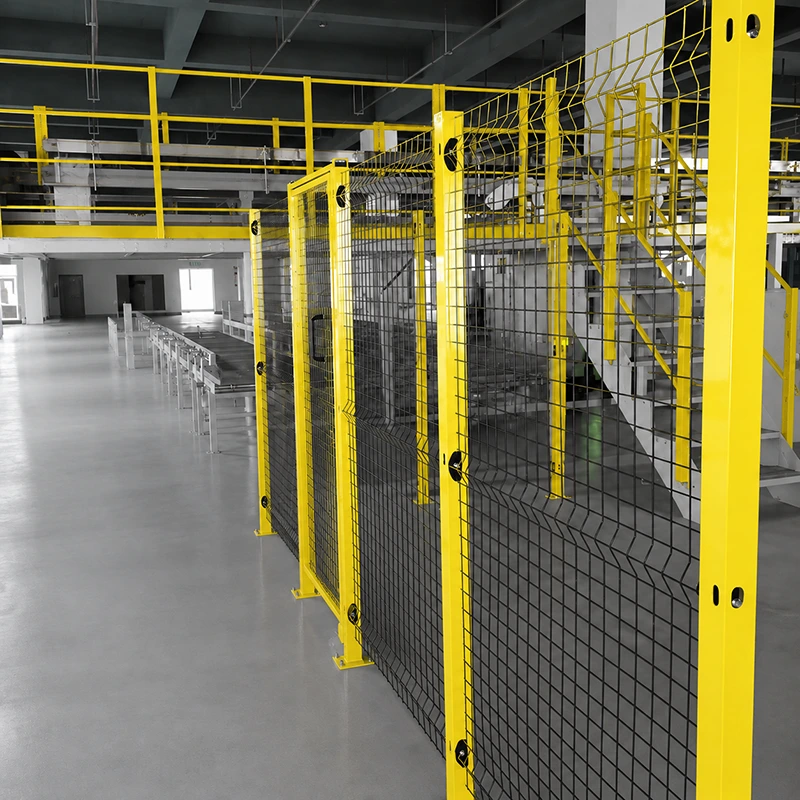 Heavy duty construction fence with powder-coated steel posts and black wire mesh guarding a factory stair and mezzanine