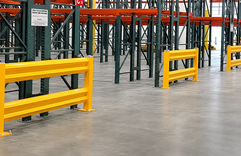 industrial guard rail protecting pallet rack uprights from forklift impact with yellow double rails