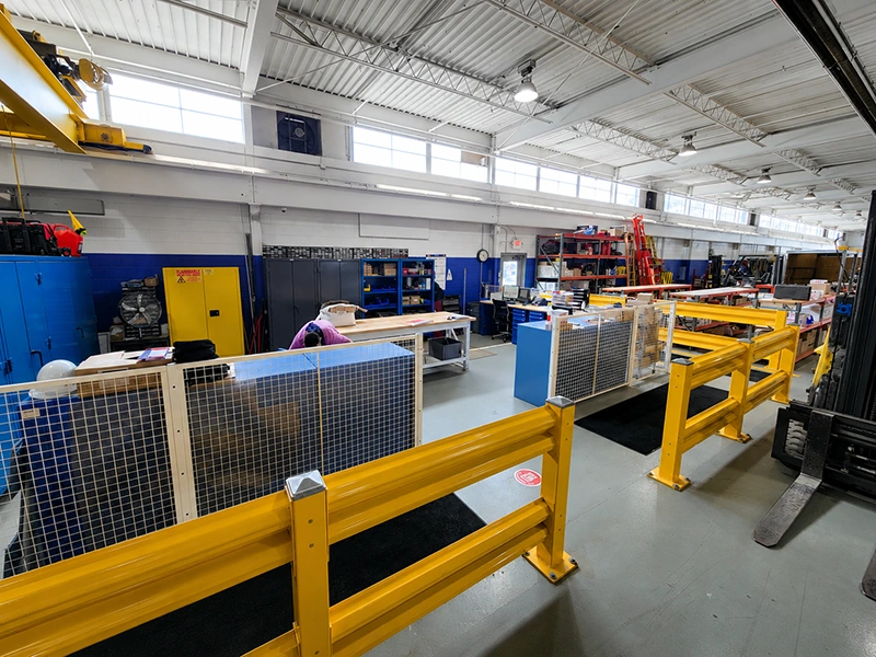 Safety barrier system with twin steel rails protecting industrial workstations from forklift impacts