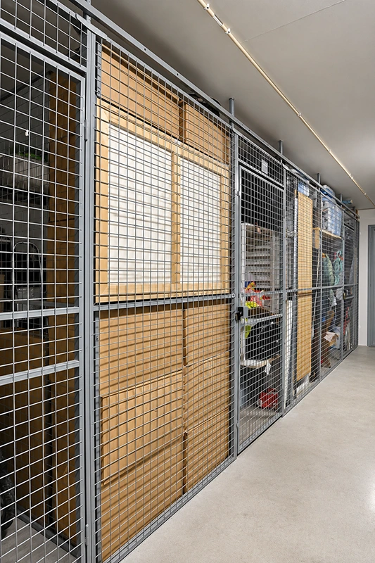 Real installation photo of SGF stlk modular wire mesh storage cages with lockable hinged doors and stored panels